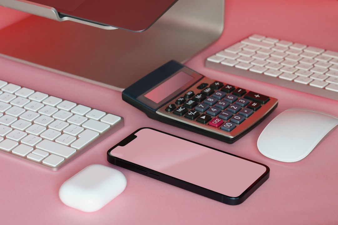A minimalist photo of a calculator, pen, and house keys on a clean, bright desk, representing the process of calculating real estate agent commissions.