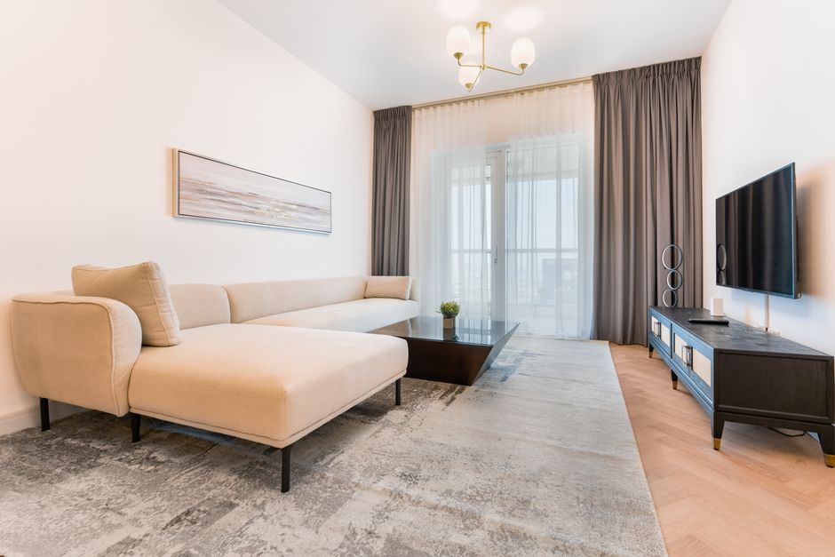 The clean and modern interior of a bright living room, professionally staged to highlight the quality service provided by the 1 Percent List HUB Model.