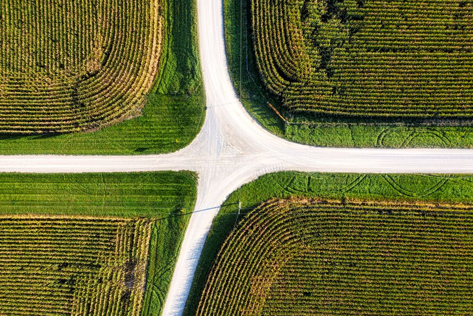A minimalist digital illustration of a crossroads with one path glowing brightly, representing the strategic shift from traditional SEO to new AI-driven marketing methods.